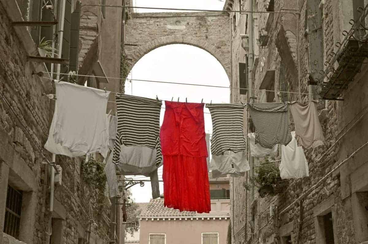 red dress and shirts on clothes line in Venice italy