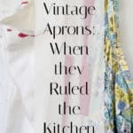 Three colorful vintage aprons hanging side by side against a white wall, with overlay text reading, Vintage Aprons: When they Ruled the Kitchen..