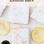 Lemon bars dusted with powdered sugar, arranged on a white surface with lemon slices. Text on the image reads, The Best Classic Lemon Bars and by theurbankitten.com.